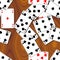 Playing cards scattered on the wooden table - seamless pattern texture background