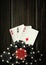 Playing cards with a winning combination of three of a kind or set on a black vintage table in a poker club. Winning in sports