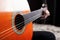 Playing the classical spanish acoustic guitar orange color