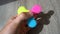 Playing with the colorful Fidget Spinner. Toy spinner in hand