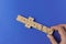 Playing dominoes on a blue background. Mans hand with domino. Leisure games concept. Domino effect