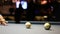 Playing Eight-ball pool billiards in a bar