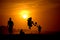 Playing footbal at the sunset on the beach