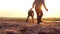 Playing football on beach at sunset, sports students relaxing on beach.