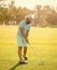 playing golfer in cap with golf club, recreation