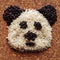 Playing with grains of rice. The head of the panda, built of cereals