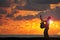 Playing guitar on the beach at sunset