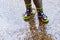 Playing in rain puddles on a urban floor with colorful spotted boots