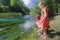 Playing siblings and kayaking sportsmen floating on Tirino river