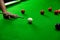 Playing snooker, piercing the red ball, black, aiming the ball and pocketing the hole to score points