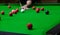 Playing snooker, piercing the red ball, black, aiming the ball and pocketing the hole to score points