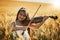 Playing to the tune of nature. Portrait of a cute little girl playing the violin while standing in a cornfield.