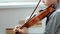 Playing the violin. Unrecognizable seven years old boy playing the violin closeup.