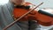 Playing the violin. Unrecognizable seven years old boy playing the violin closeup. Front view.