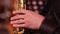 Playing on a wooden wind instrument soprano saxophone. Close-up. The musician retrieves the sounds of music by clamping the keys a