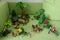 Playmobil toys of woodland animals arranged on green sofa