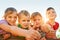 Playtime is the best time. Portrait of a group of little children showing thumbs up while playing together outdoors.