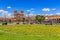 Plaza de Armas main square with cathedral and yellow flowers  in foreground, Cuzco, Peru