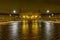 Plaza de EspaÃ±a in Seville, night scene after raining with long exposure photo and reflections of lights in water and cobbled