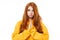 Pleading young redhead woman girl in casual yellow hoodie posing isolated on white background studio portrait. People