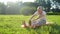 Pleasant aged man doing stretching exercises on the exercise mat