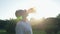 Pleasant aged man drinking water after spoort exercises