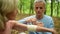 Pleasant aged man putting bandage on his wife elbow