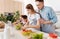 Pleasant caring father teaching his daughter to cook