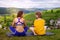 Pleasant communication. Happy delighted young woman smiling and talking to her friend while sitting on  yoga mat.