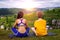 Pleasant communication. Happy delighted young woman smiling and talking to her friend while sitting on  yoga mat.