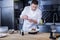 Pleasant cook preparing a wonderful dish in the kitchen