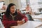 Pleasant delighted casual woman sitting in the cafe