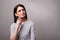 Pleasant delighted girl standing isolated on grey background