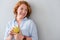 Pleasant delighted woman holding apple