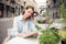 Pleasant delighted woman sitting at the table outside