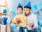 Pleasant father helping little son blow out birthday candle