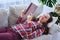 Pleasant female having rest while reading book