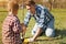 Pleasant little boy and his father planting a tree