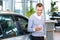 Pleasant man choosing car in auto show