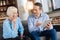 Pleasant man explaining how to use tablet to his mother