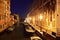 Pleasant night view of a canal in Venice with historic buildings on the side and boats floating on the water