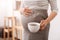 Pleasant pregnant woman holding a cup of coffee