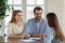 Pleasant smiling young married couple meeting with female bank consultant