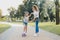 Pleasant stylish preschool girl having active walk with her mother