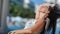 Pleasant tan woman in glasses playing hair relaxing sunbathing at luxury resort medium close-up