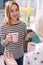 Pleasant woman drinking coffee with mother in kitchen