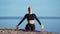 Pleasant woman meditating practicing yoga breathing raising hands on beach. 4k Dragon RED camera