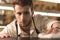 Pleasant young barman checking the cleanness of bar counter