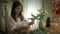 Pleasant young woman small business owner making beautiful bouquet of flower at her flower shop