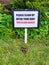 Please clean up after your dog - sign in a garden following a dog paying the lawn a visit